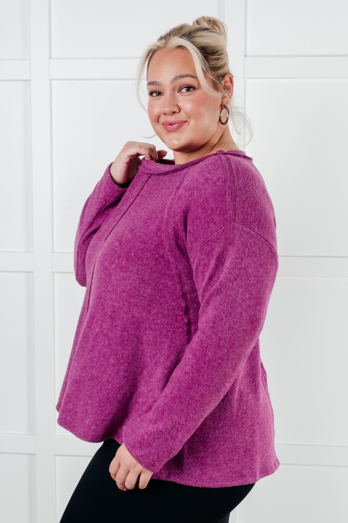 Women's Brushed Hacci Sweater in light plum featuring a round neckline, drop shoulders, stepped hemline, side slits, and raw seams. 