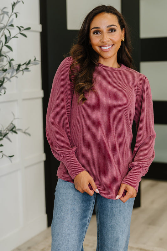 Model wearing Shannon Balloon Sleeve Knit Top in berry, cable ribbed knit with round neckline