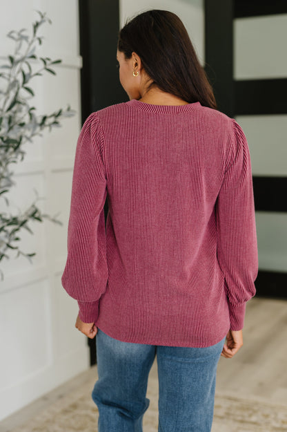 Back of Shannon Balloon Sleeve Knit Top, cable ribbed knit in berry with exaggerated banded cuffs