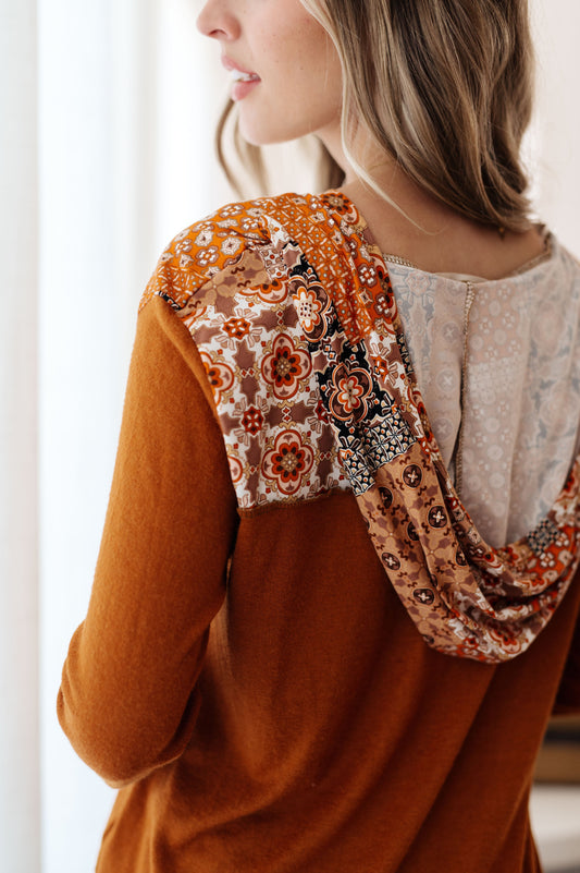 Back close-up of Trissie Mixed Print Hoodie, showcasing mixed print hood detail and exposed seams.