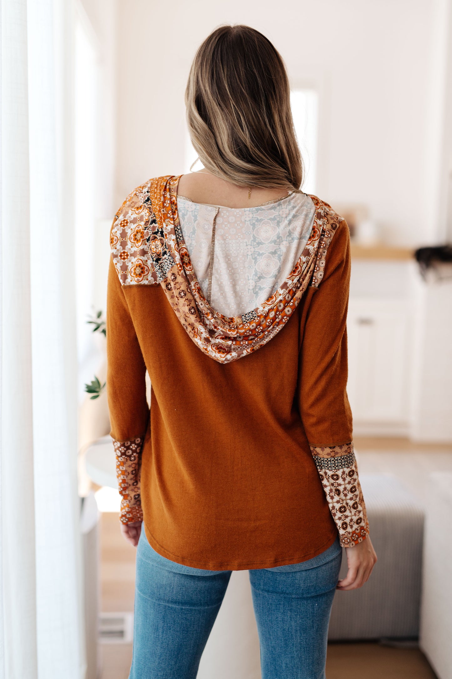Full back view of Trissie Mixed Print Hoodie, showing patterned hood and exposed seams down the back.