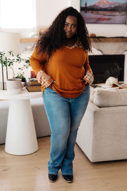 Plus-size full body view of Trissie Mixed Print Hoodie, relaxed fit with V-neckline and patterned details.