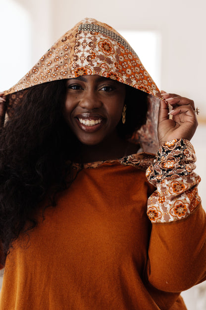 Close-up of model wearing Trissie Mixed Print Hoodie with hood up, highlighting patterned lining.