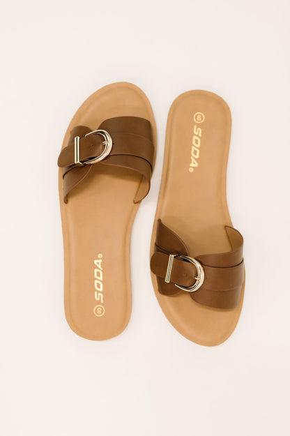 Flat lay of Siran Dark Tan Slip-On Sandals by Soda faux leather strap and neutral tone.