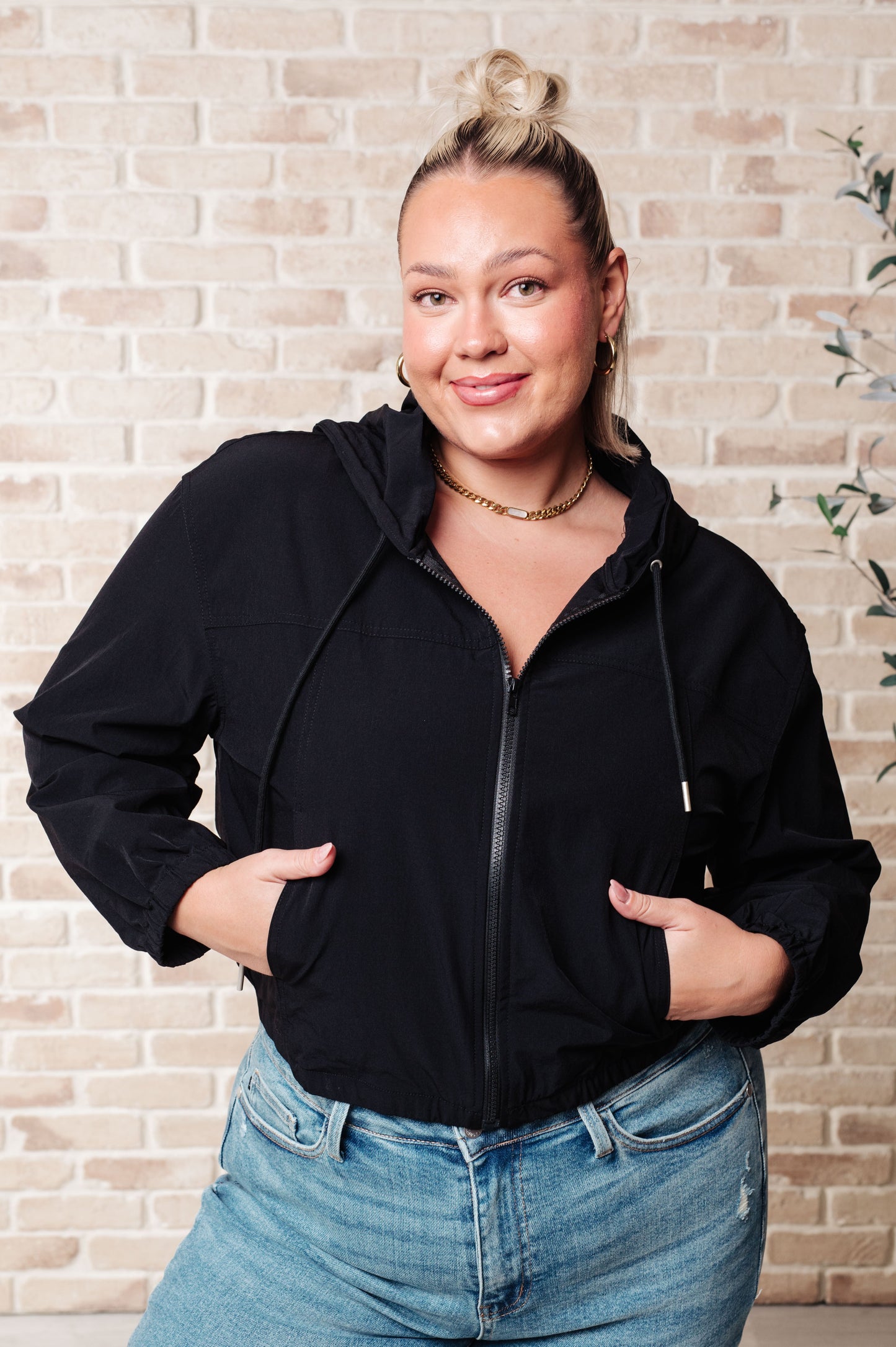 Front view of plus size Sky Zip Up in Black showing elastic waistband and pockets.