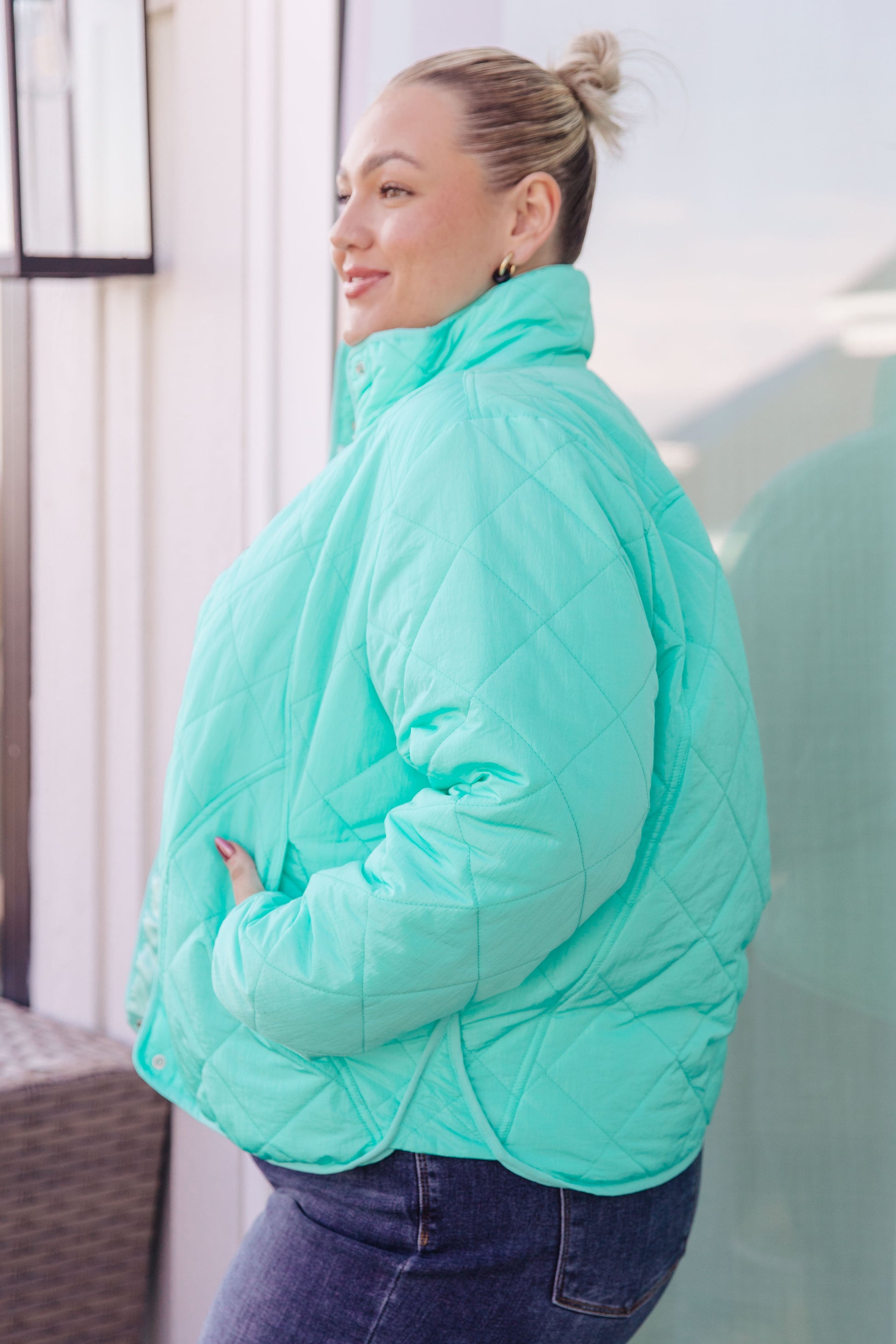 Side angle of plus size Siyah Puffer Jacket highlighting turquoise hue and long sleeves.