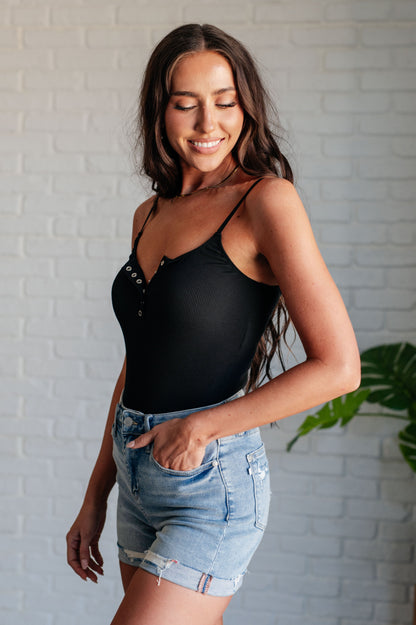 Shop the Sleek and Modern Saylor Bodysuit, Perfect for Pairing with Jeans or Skirts, Features Adjustable Spaghetti Straps and Snap Closure.