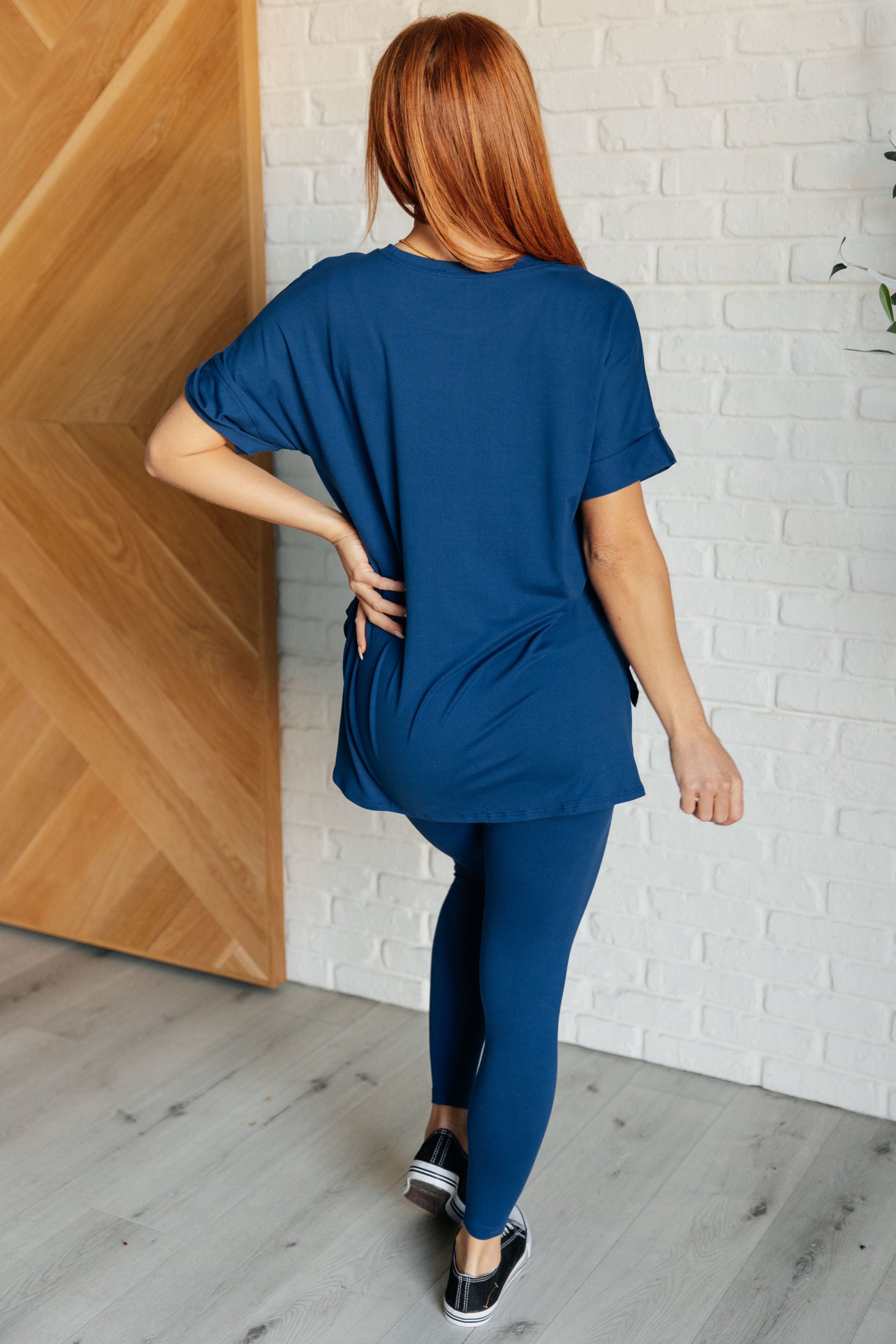 Women's light navy top and leggings set made with brushed microfiber. The top has a round neckline, dolman sleeves, and a high-low hemline with side slits. The leggings have a cased elastic waistline.