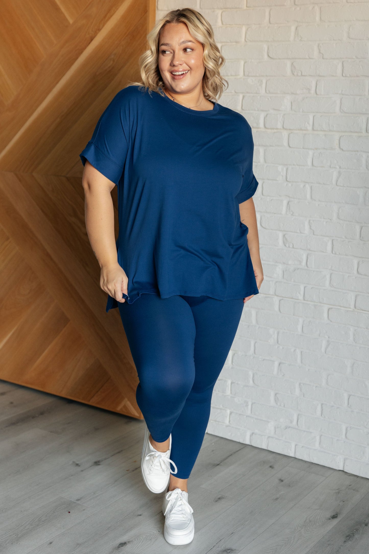 Women's light navy top and leggings set made with brushed microfiber. The top has a round neckline, dolman sleeves, and a high-low hemline with side slits. The leggings have a cased elastic waistline.