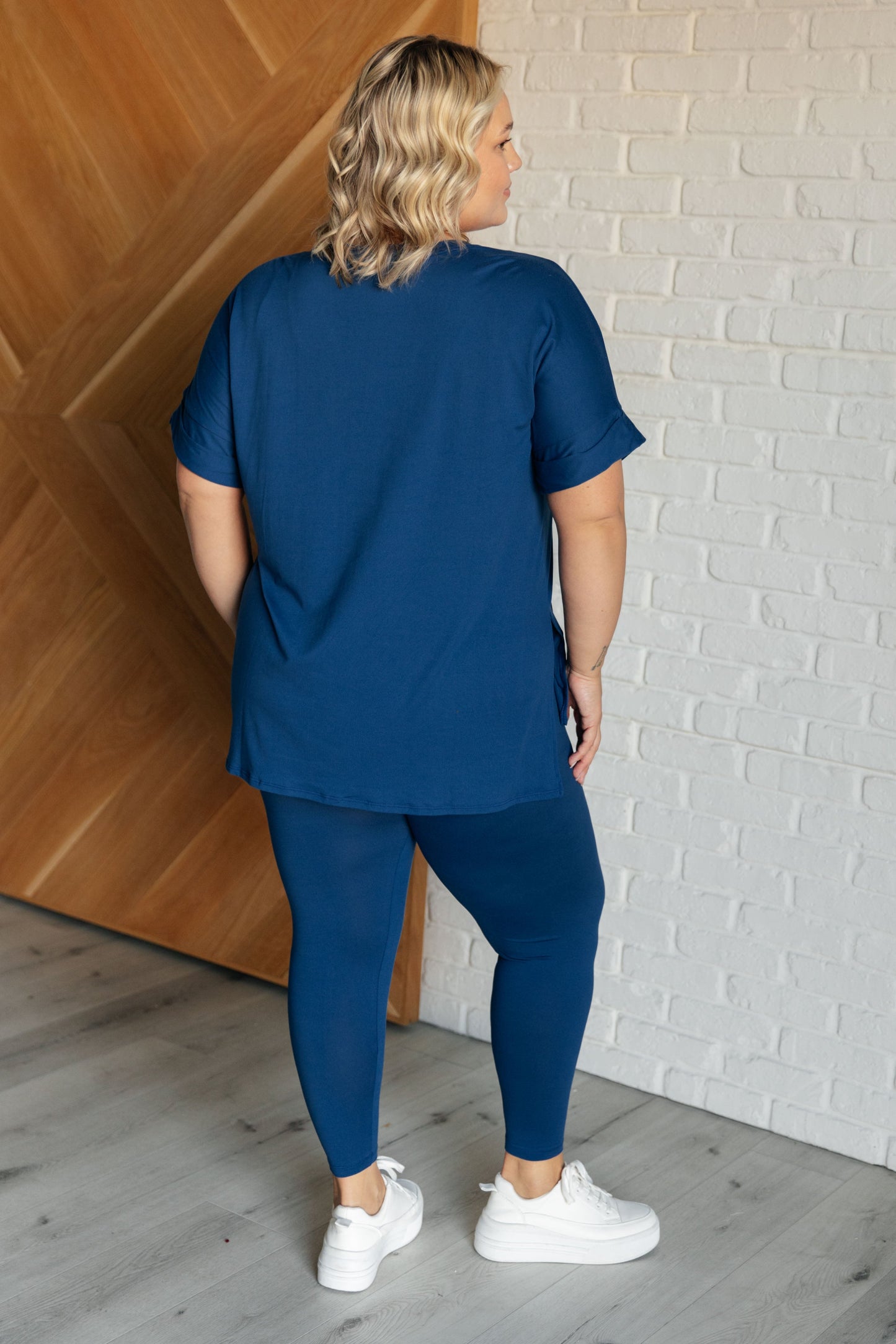 Women's light navy top and leggings set made with brushed microfiber. The top has a round neckline, dolman sleeves, and a high-low hemline with side slits. The leggings have a cased elastic waistline.