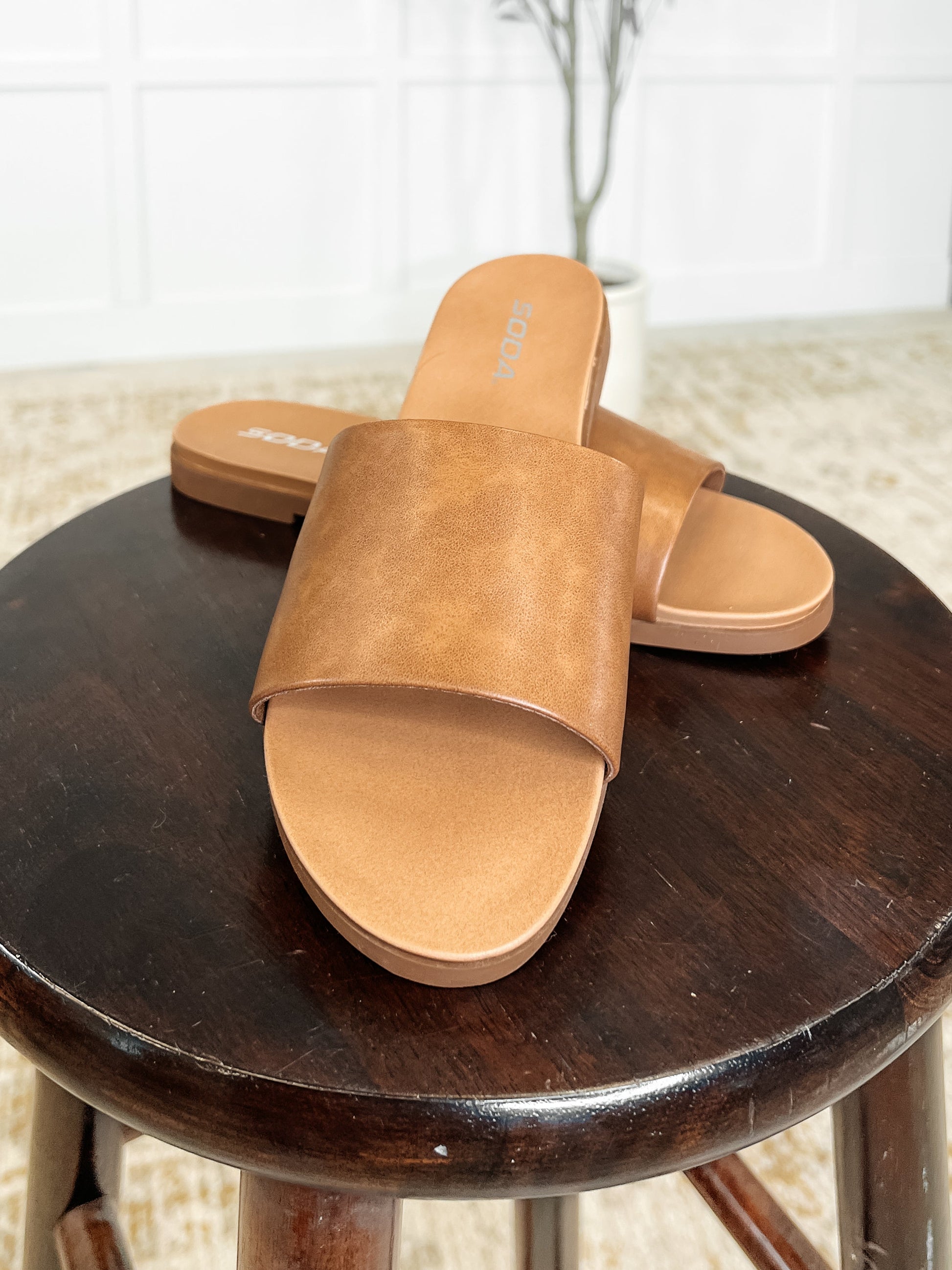 Casual tan slip on sandals with open toe, perfect for everyday wear, vacations, and warm weather outfits.