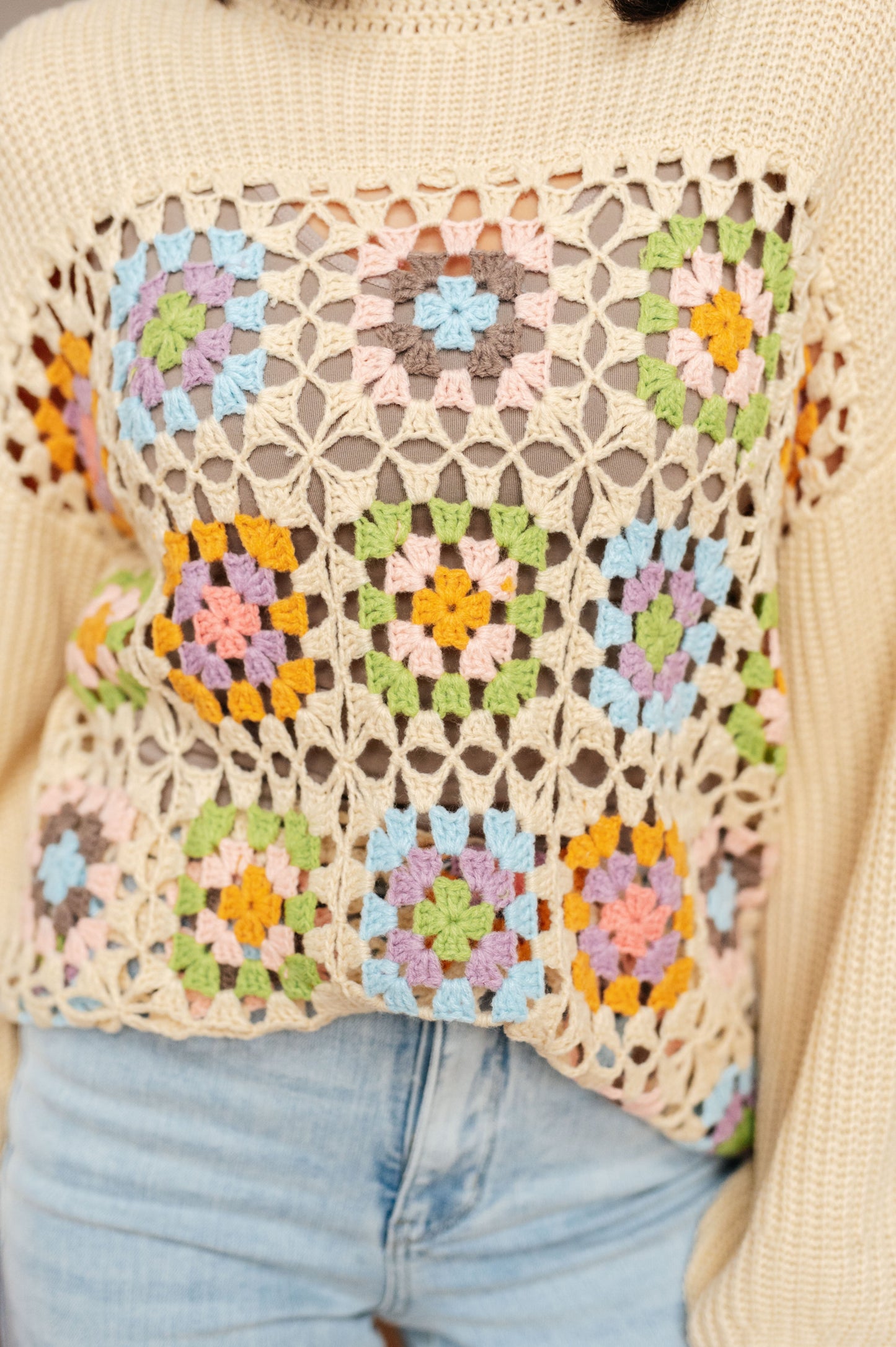Close-up of Granny Square Sweater showing crochet granny square lace detail.
