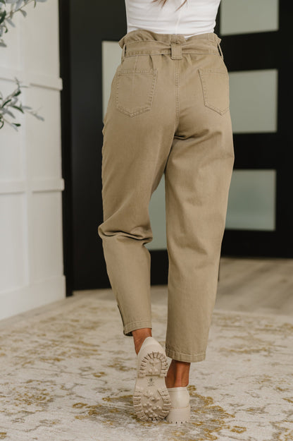 Model wearing Audie High Waist Trousers from the back, showing patch pockets and tailored fit.