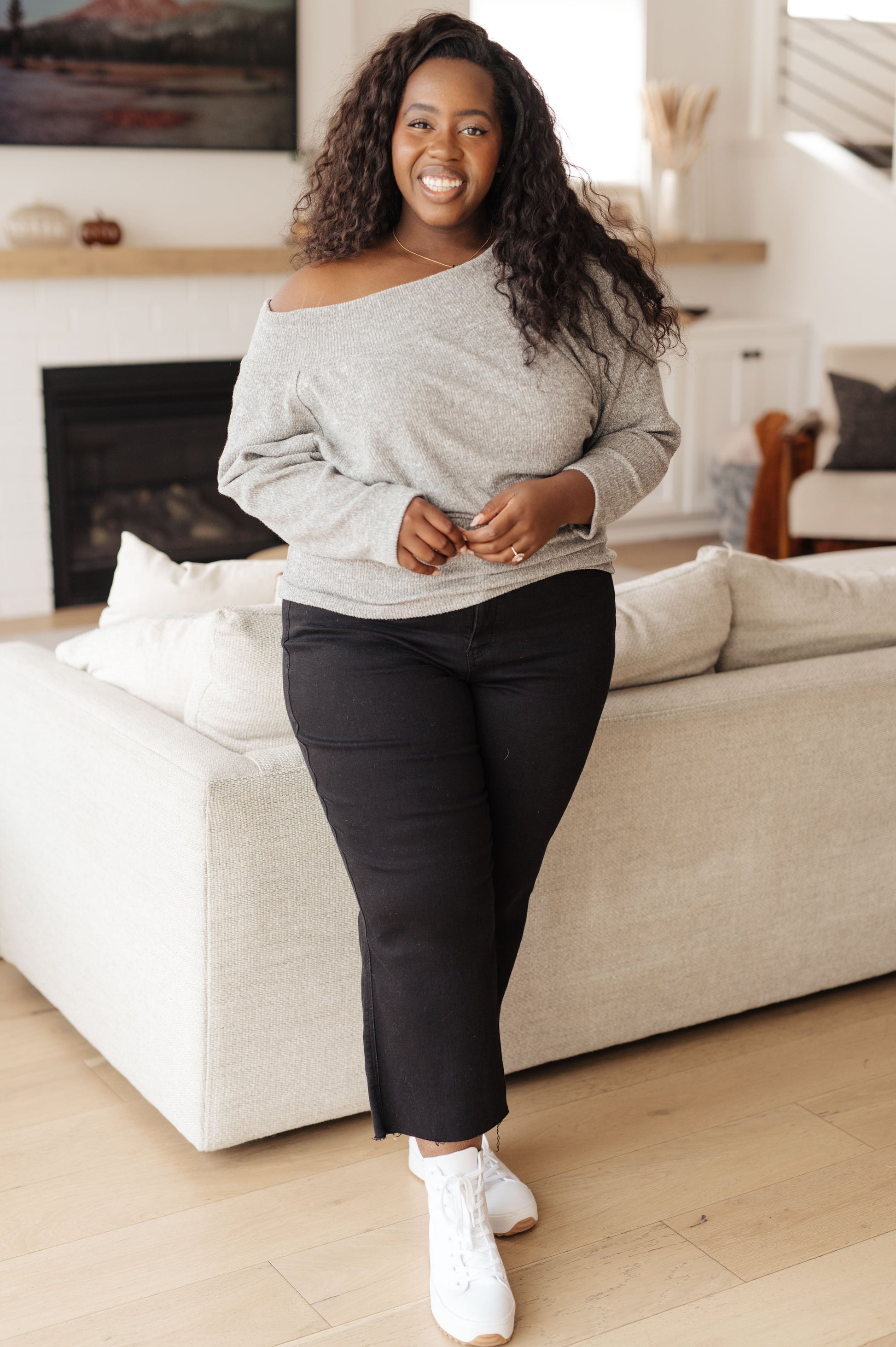 Light gray textured knit top features a boat neckline, and dolman sleeves.