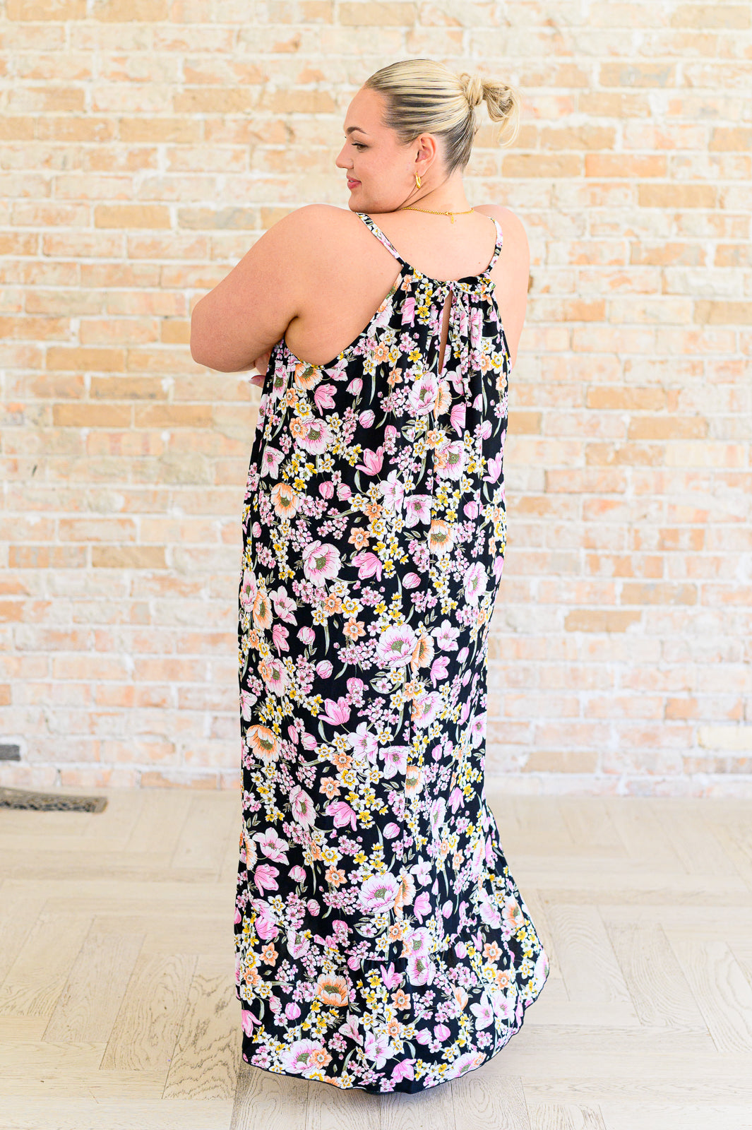 Plus size back view of Samantha Halter Dress showing floral print, halter tie, and exaggerated hemline.