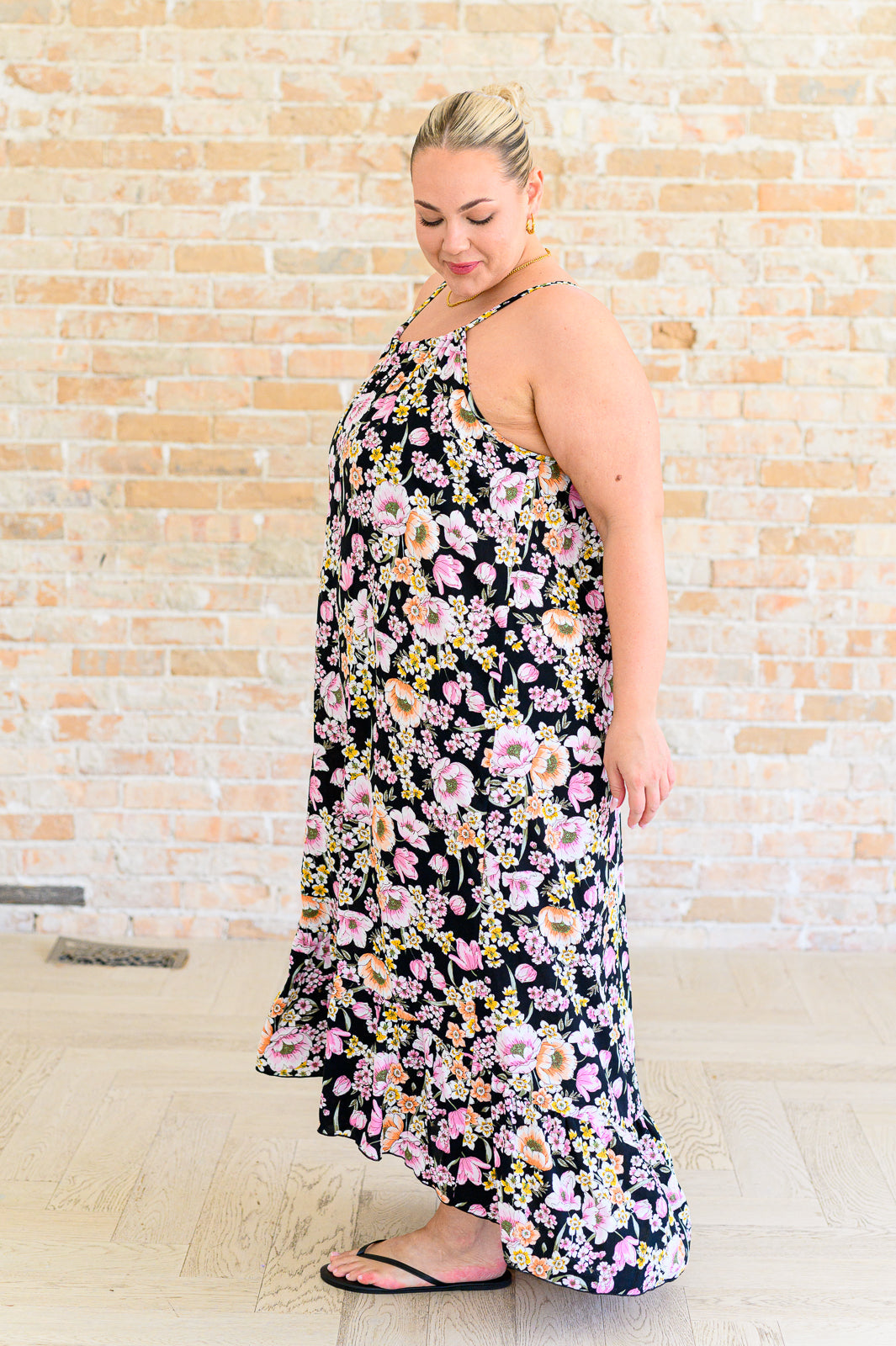 Side view of plus size Sunny Halter Floral Dress flowy ruffle hem silhouette.