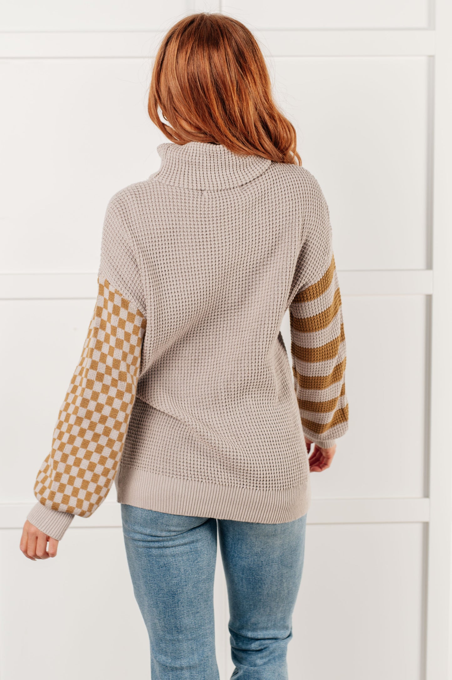 Suzi Patchwork Waffle Knit Sweater with a soft waffle knit texture, turtle neckline, drop shoulder design, and banded ribbed details, featuring check and striped patterns.