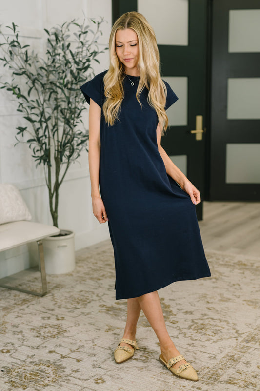 Model wearing Sweeney Casual Dress in Navy jersey knit with crew neckline and side slit.