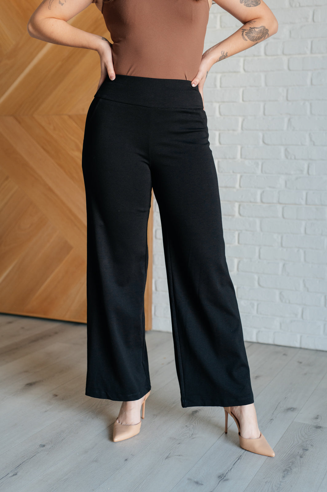 Wide Leg Pants in black, made from high-stretch ponte knit fabric, featuring faux welt pockets and a flattering wide leg silhouette.