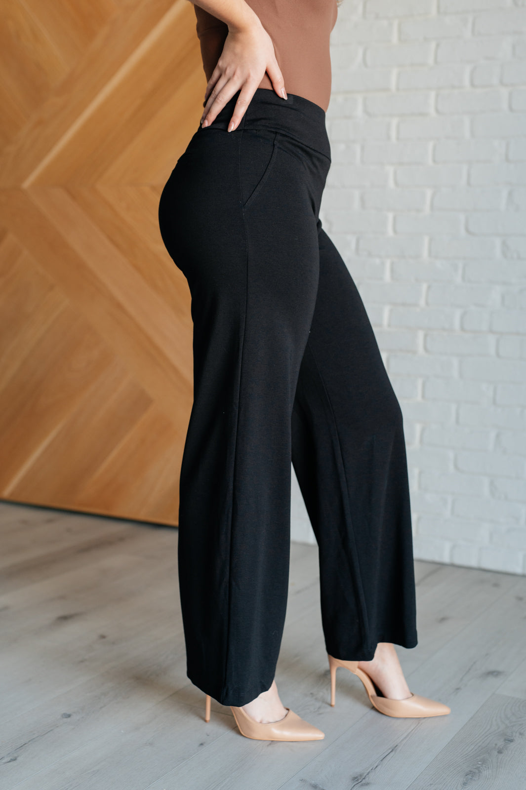 Wide Leg Pants in black, made from high-stretch ponte knit fabric, featuring faux welt pockets and a flattering wide leg silhouette.