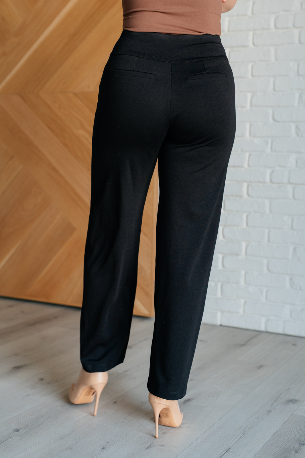 Wide Leg Pants in black, made from high-stretch ponte knit fabric, featuring faux welt pockets and a flattering wide leg silhouette.