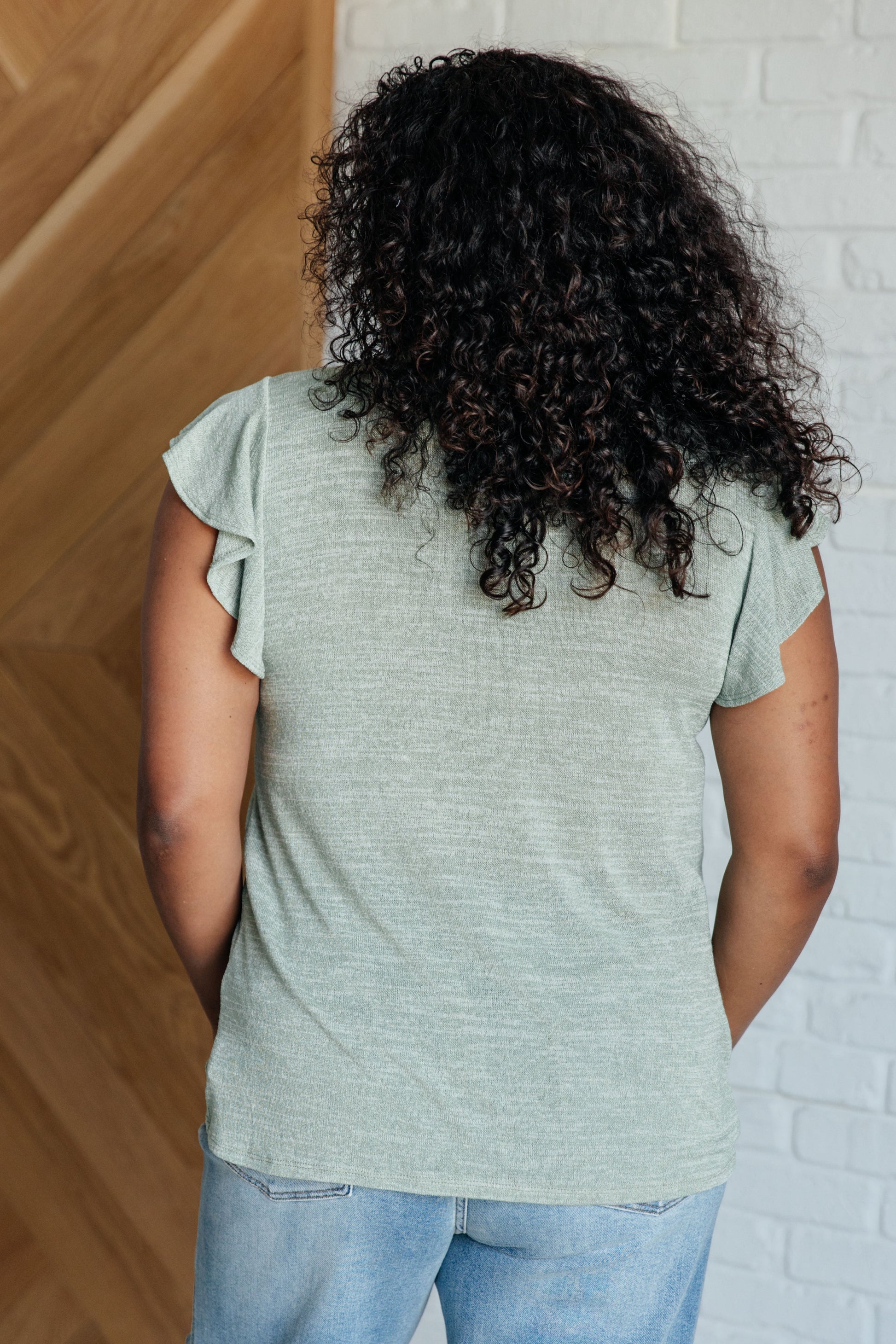 Plus size back view of Teresa Flutter Sleeve Top in sage, flutter sleeves and relaxed jersey knit