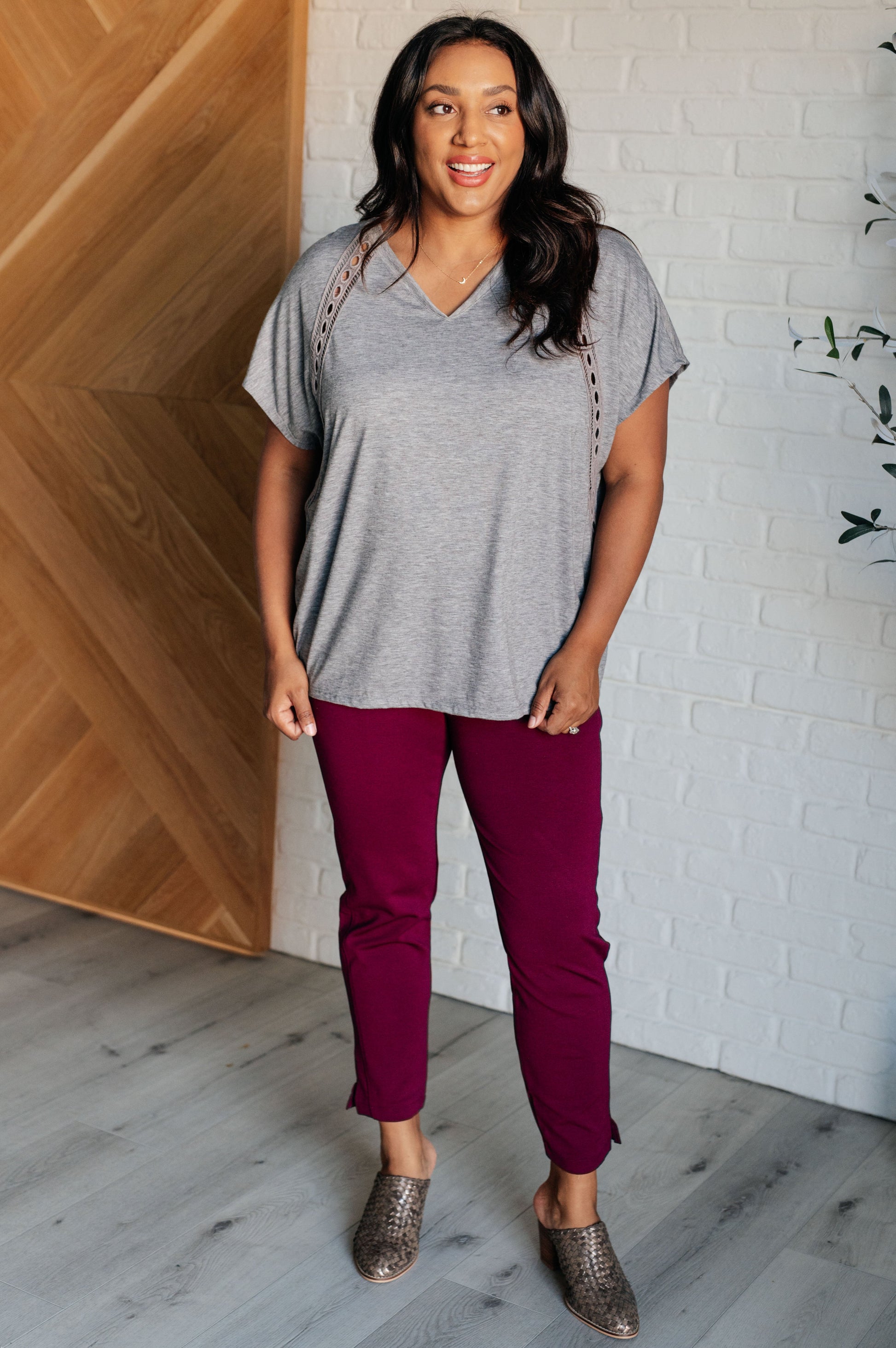 Siana Eyelet Trim Top in gray with V-neckline, batwing sleeves, eyelet trim detailing, and a stepped hemline.