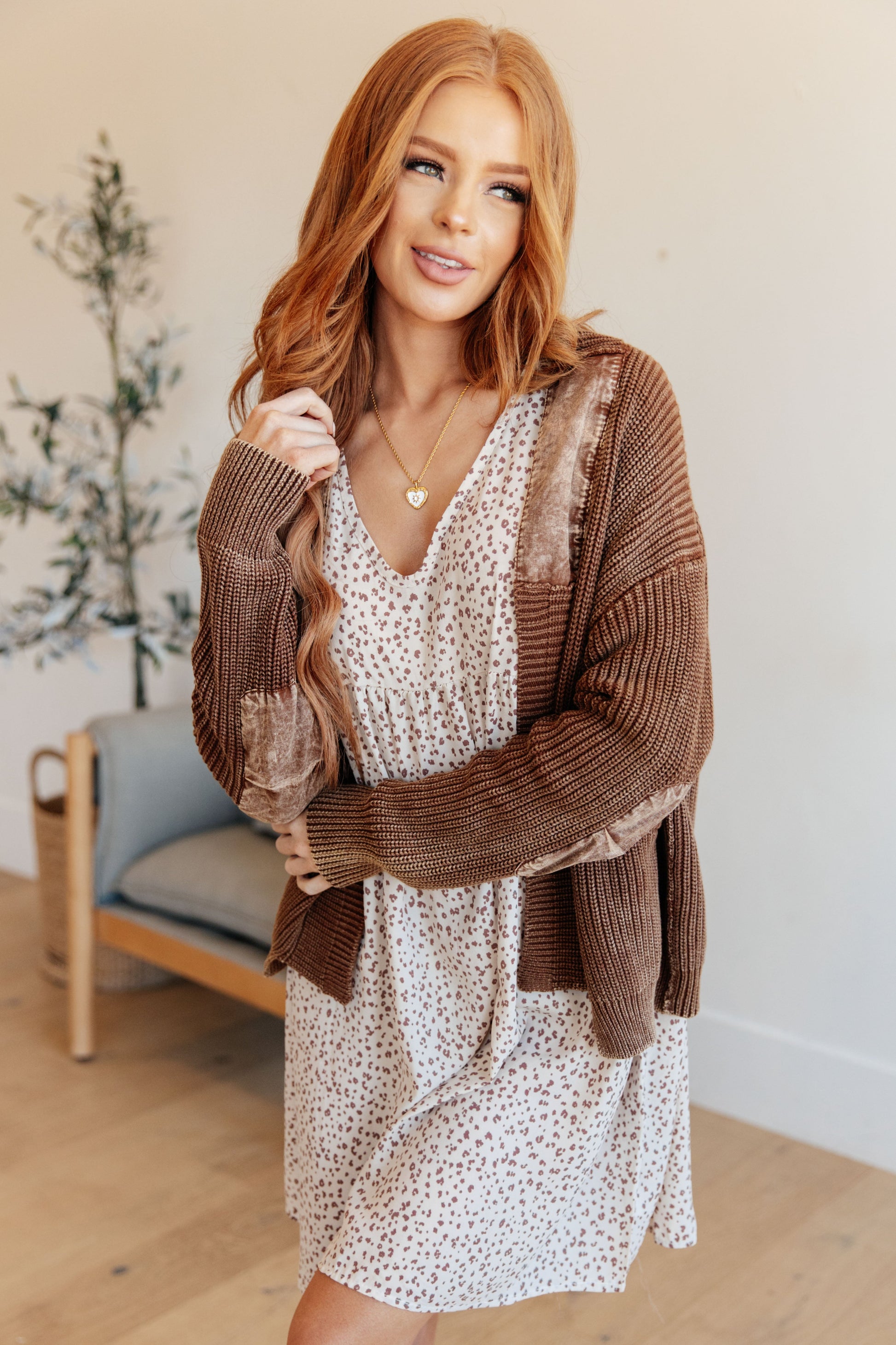 Model wearing Talia Grandpa Cardigan in brown mineral wash with elbow patches and open front.