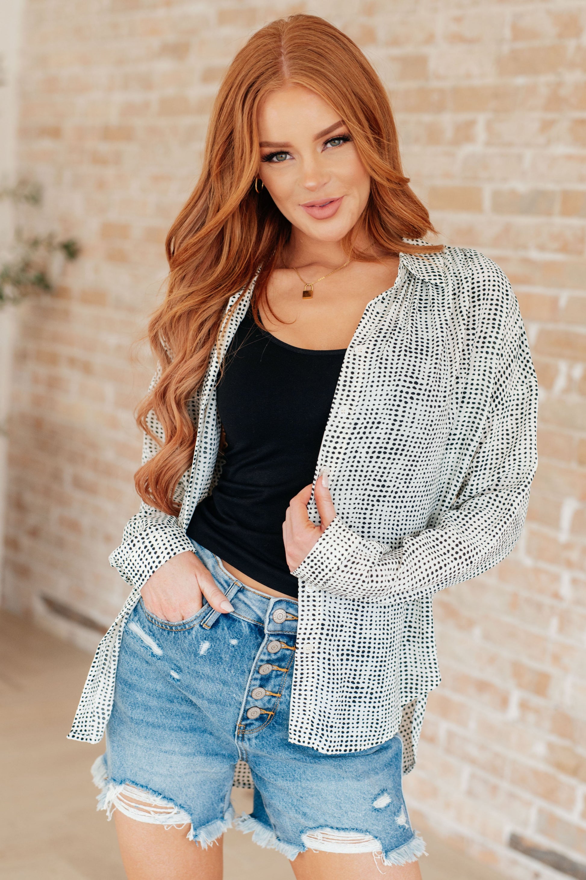 Model in Brandi Dolman Sleeve Button Up, black/white patterned satin fabric with button-down front