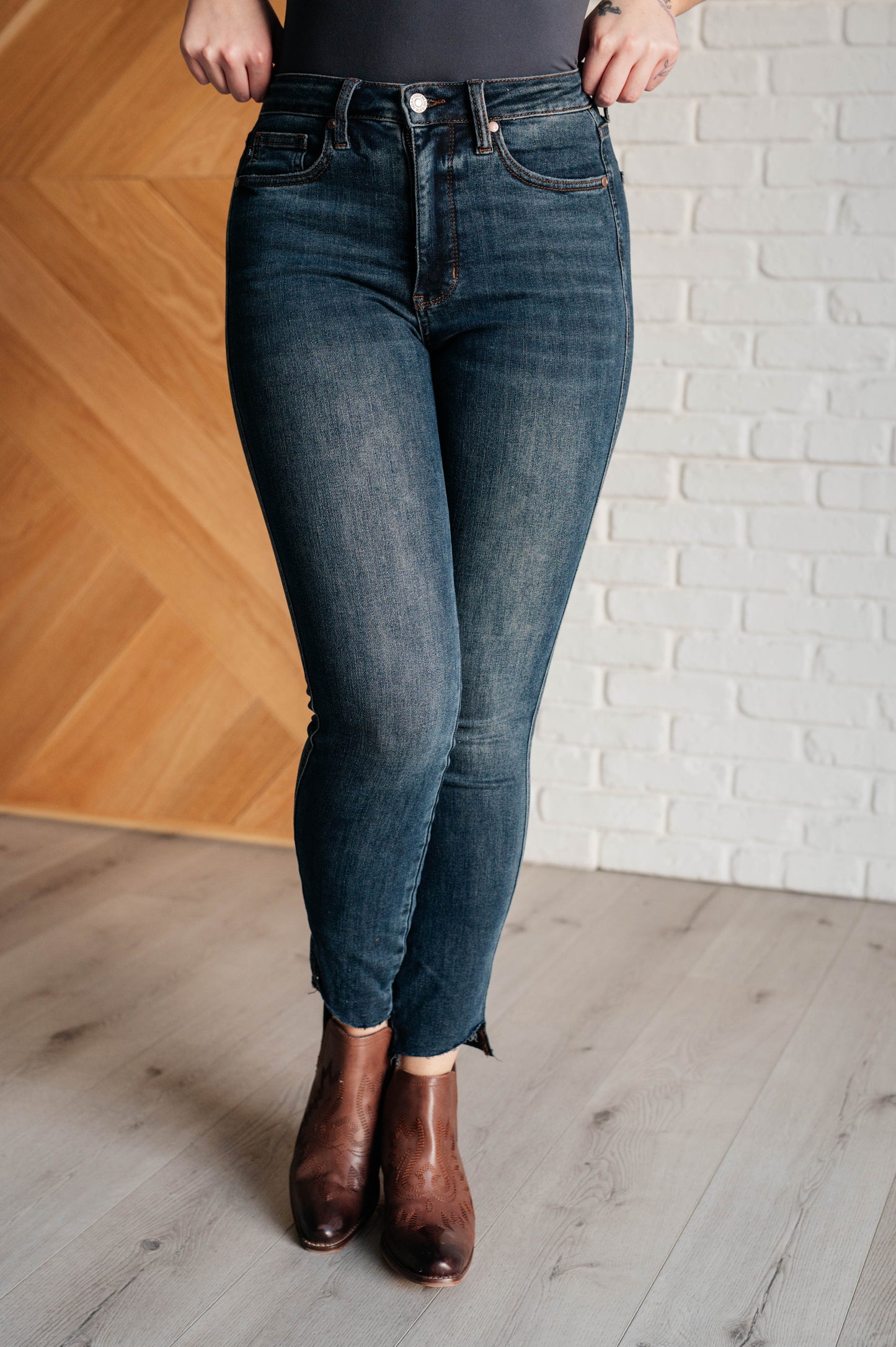 Tessa High Rise Control Top Step Hem Skinny Jeans with a flattering high rise, slimming tummy control, and stylish stepped raw hem in dark wash, perfect for any occasion.