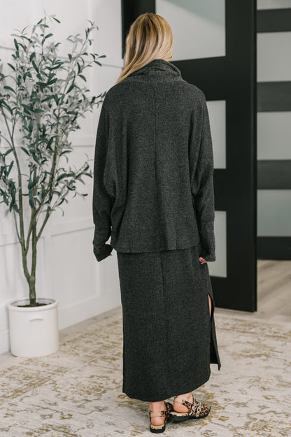 Back view of Wannetta Set in Black with textured waffle knit and exaggerated sleeve cuffs.