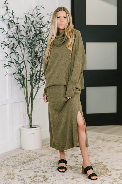Model wearing Wannetta Set in Olive with cowl neck top and sleeveless dress in waffle knit fabric.