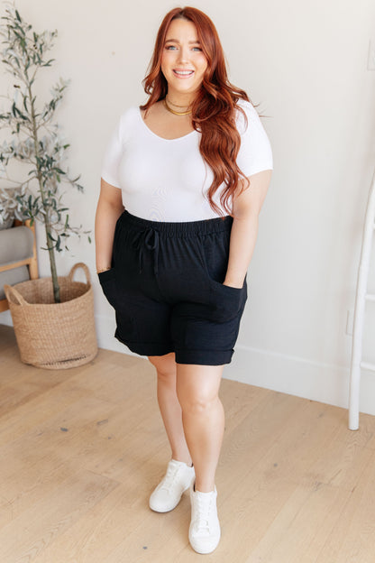 Plus size full body view of Gracelyn Drawstring Shorts in black styled with white tee and sneakers.