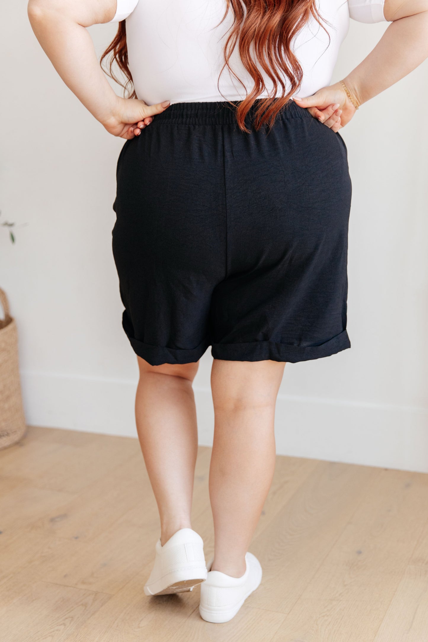Plus size back view of Gracelyn Drawstring Shorts in black with elastic waistband and oversized leg.