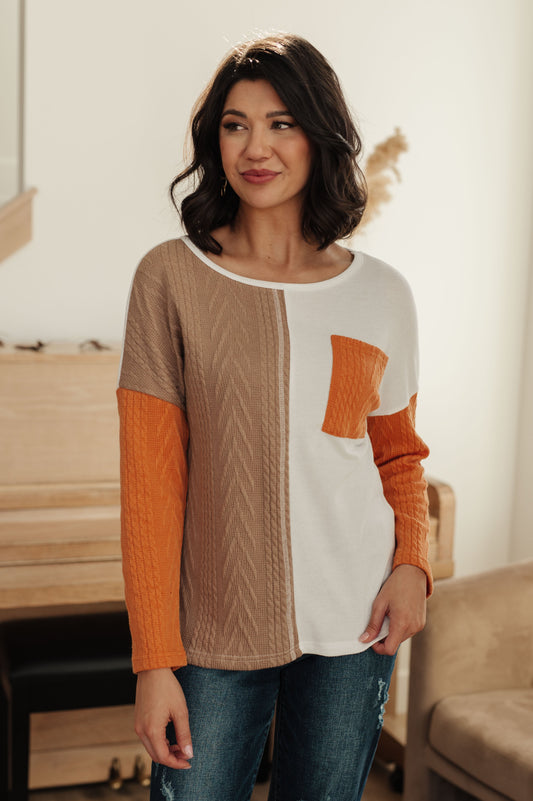 Front view of Cleo Colorblock Top with orange, beige, and white design