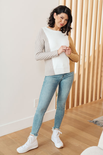 Model in Makenna Color Block Sweater styled with light wash jeans and white sneakers.
