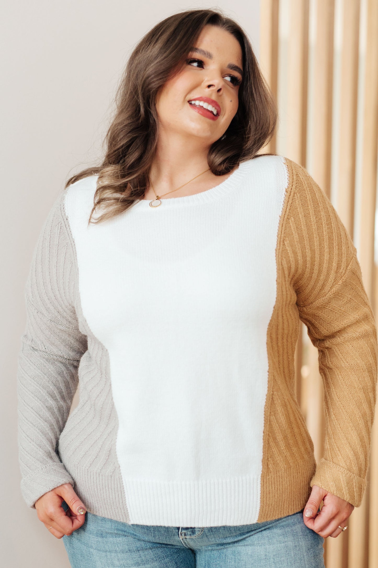 Plus size model wearing Makenna Color Block Sweater showing color block and slim fit.
