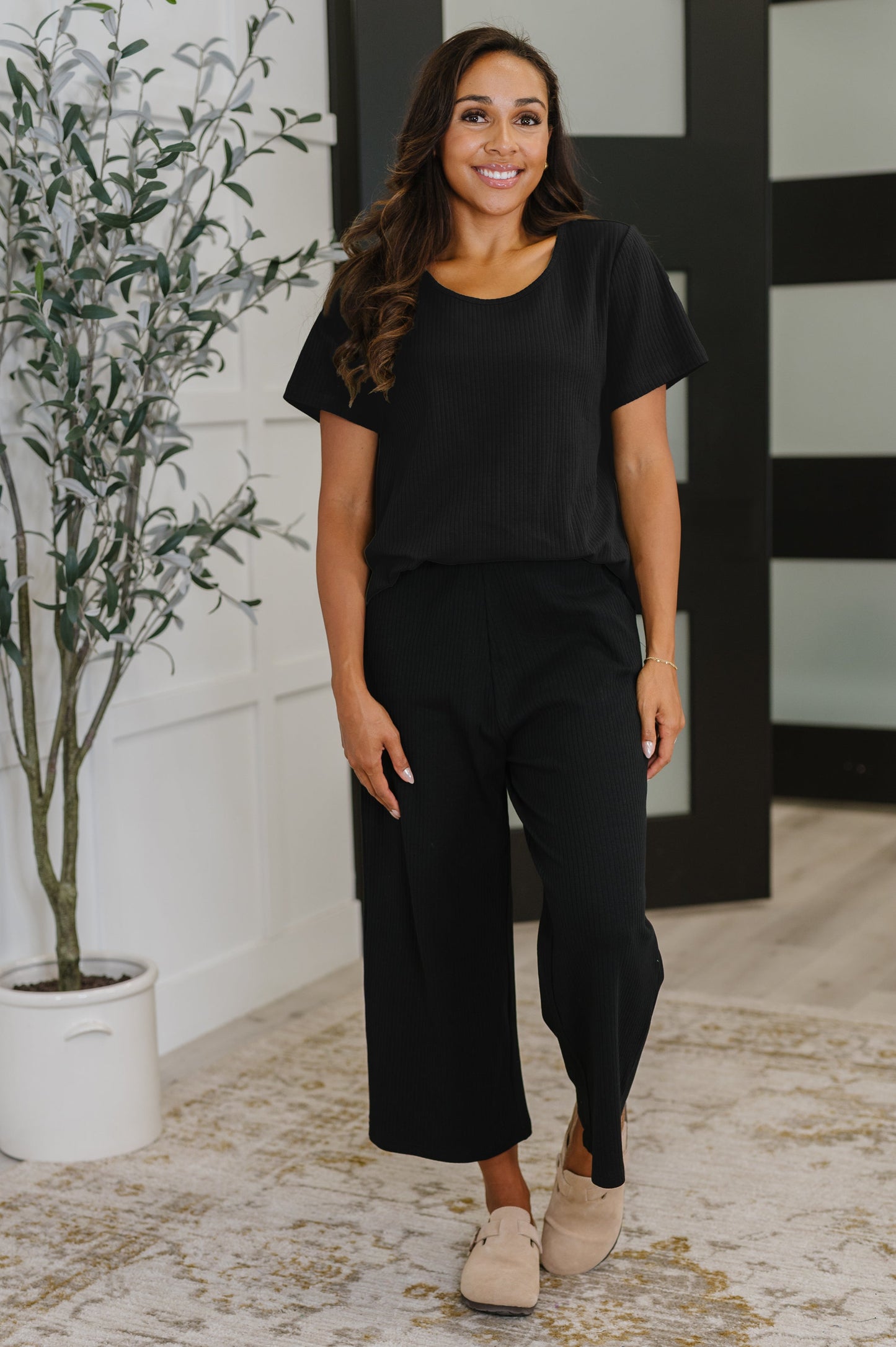 Model wearing Thyme Boxy Tee in Black full body styled with matching culottes