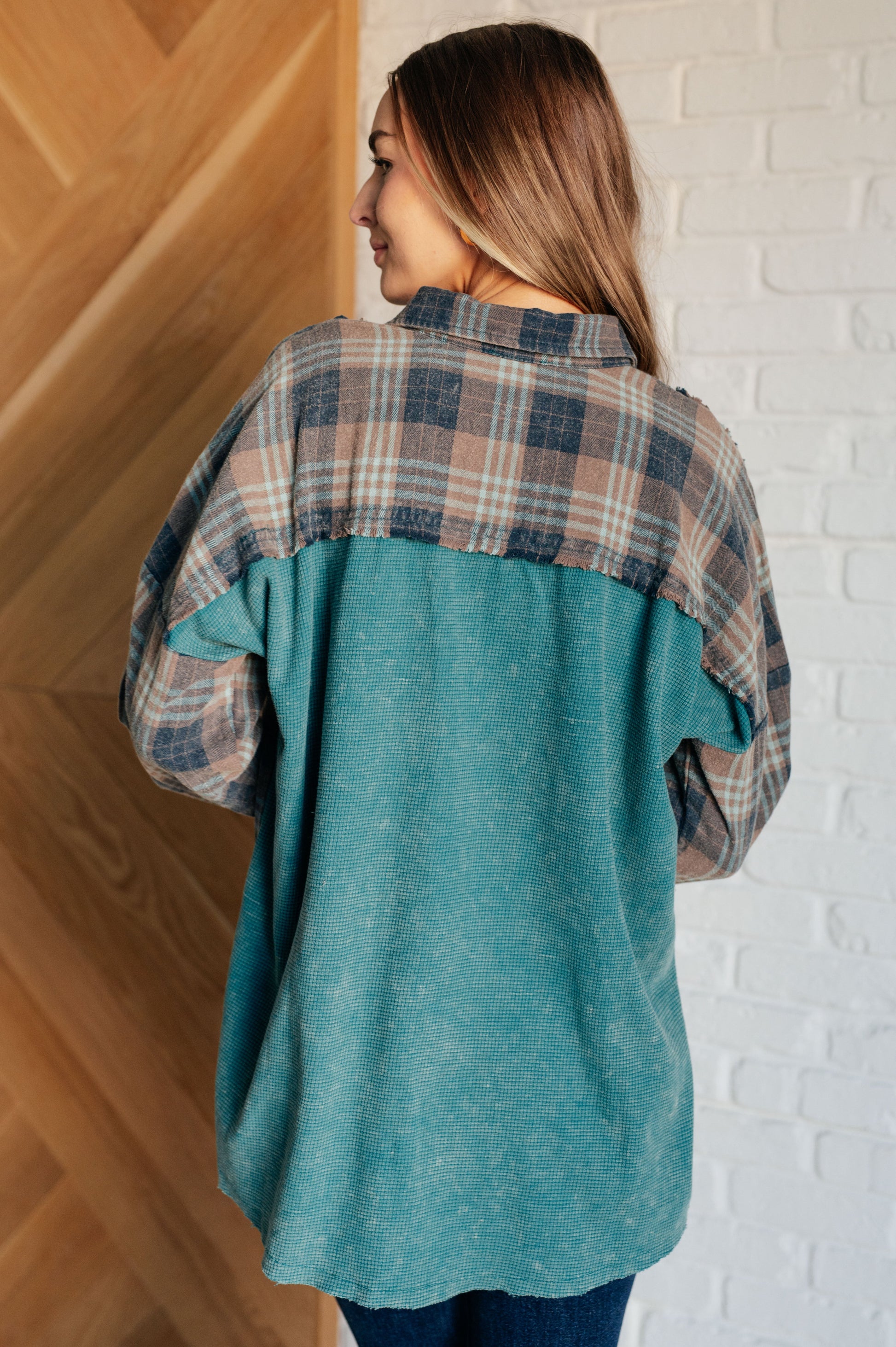 Women's teal plaid button-up shirt with a mix of flannel and waffle knit, featuring chest pockets, button-up closure, and a raw hem for a modern and stylish look.