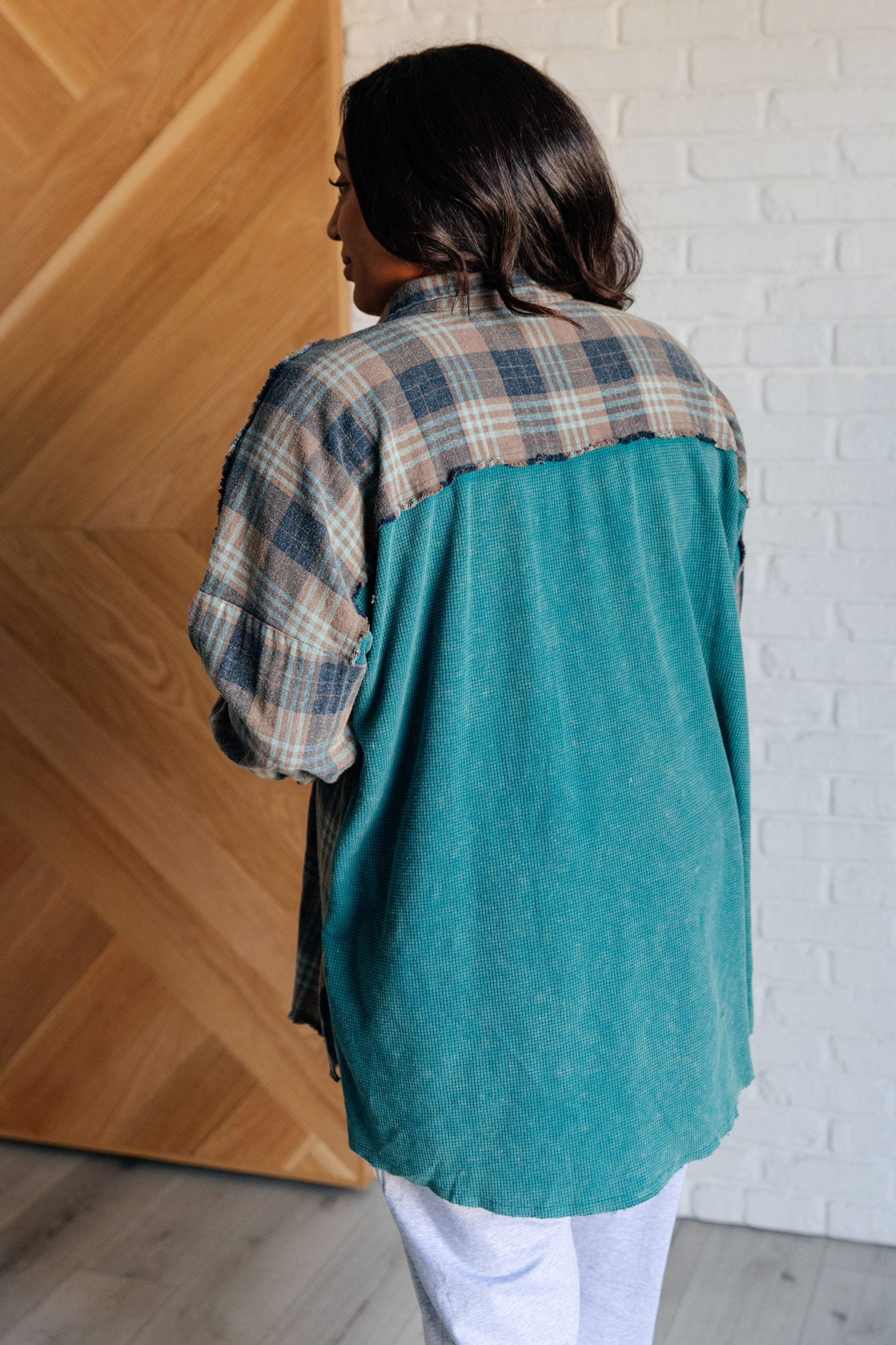 Women's teal plaid button-up shirt with a mix of flannel and waffle knit, featuring chest pockets, button-up closure, and a raw hem for a modern and stylish look.