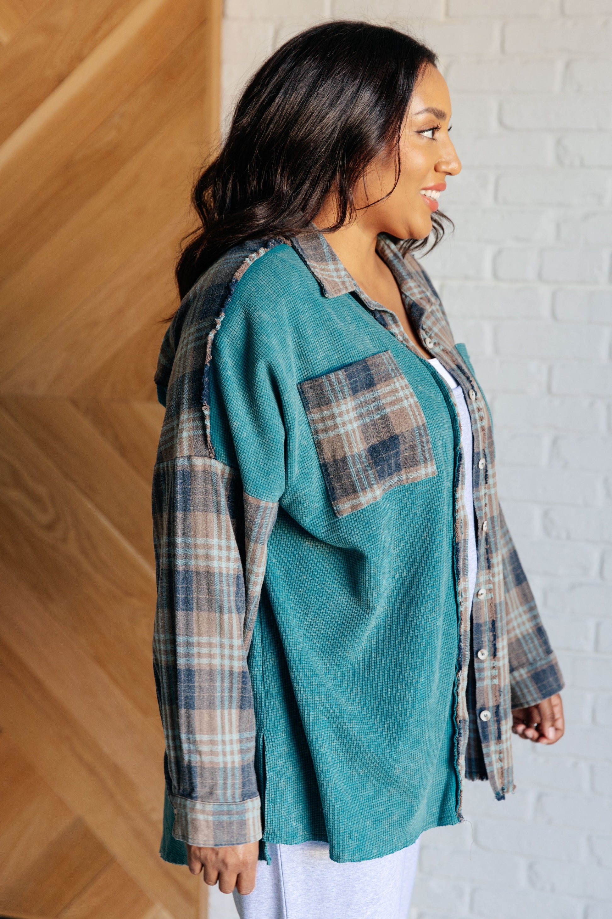 Women's teal plaid button-up shirt with a mix of flannel and waffle knit, featuring chest pockets, button-up closure, and a raw hem for a modern and stylish look.