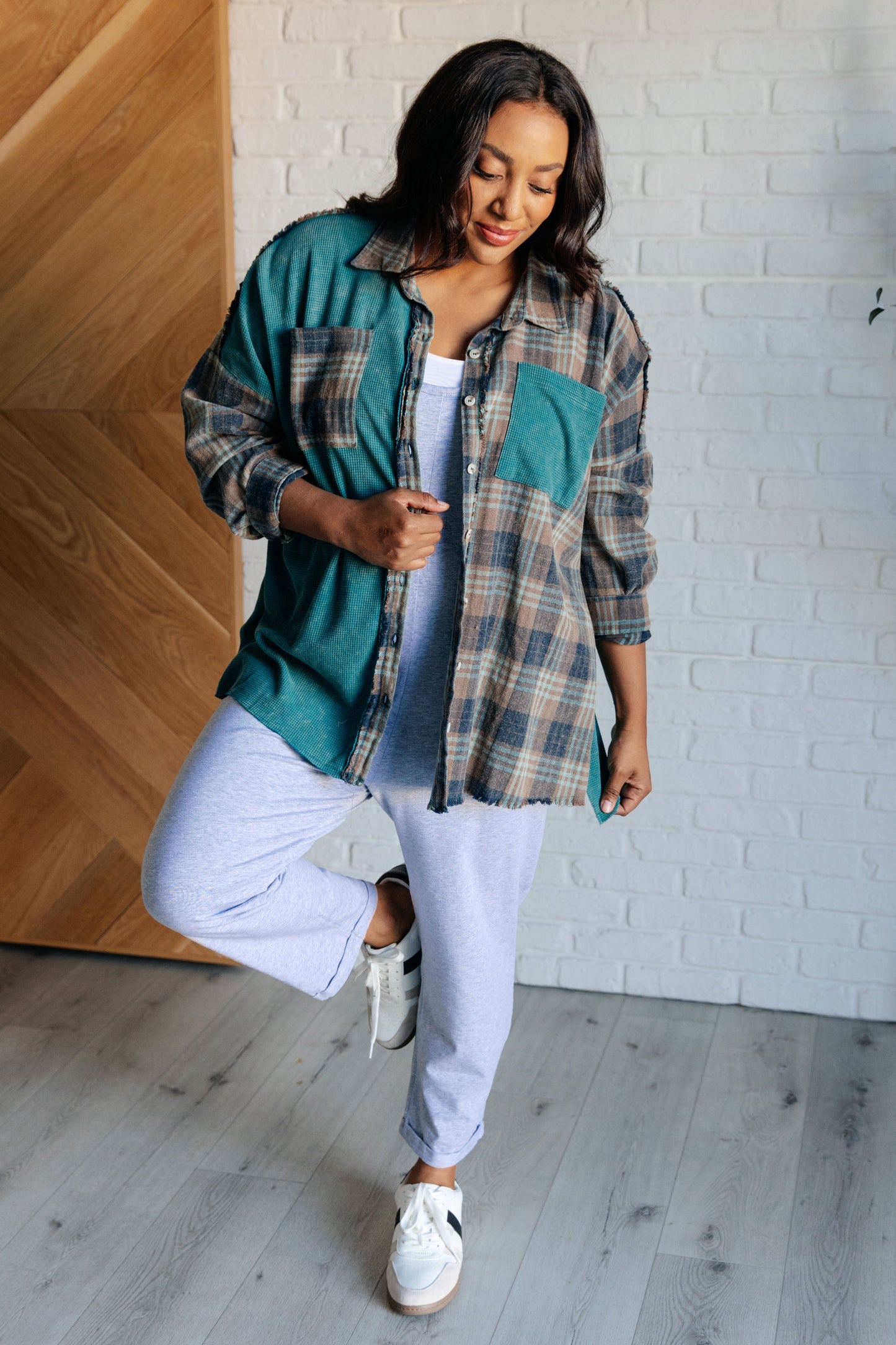 Women's teal plaid button-up shirt with a mix of flannel and waffle knit, featuring chest pockets, button-up closure, and a raw hem for a modern and stylish look.