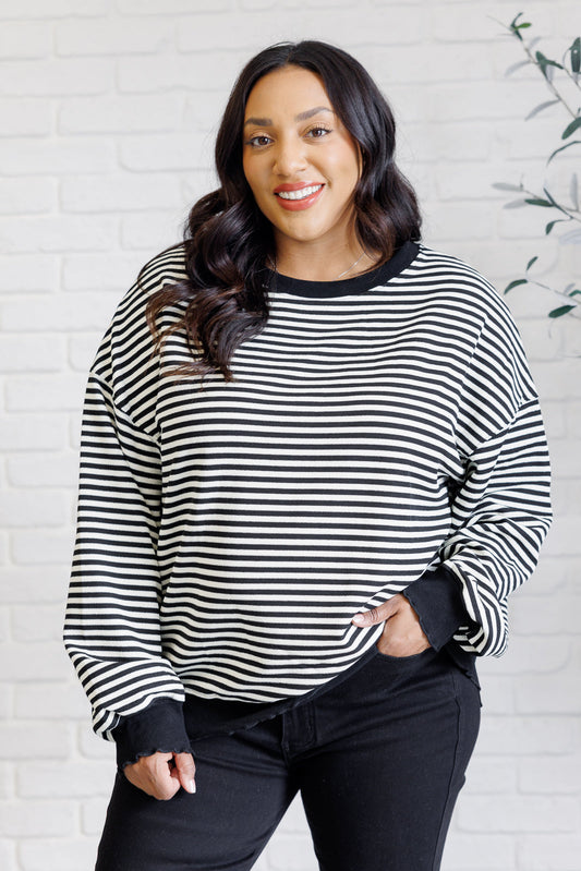 Women's black striped drop shoulder top with long sleeves, banded ribbed neckline, cuffs, and hemline, made of midweight knit fabric.