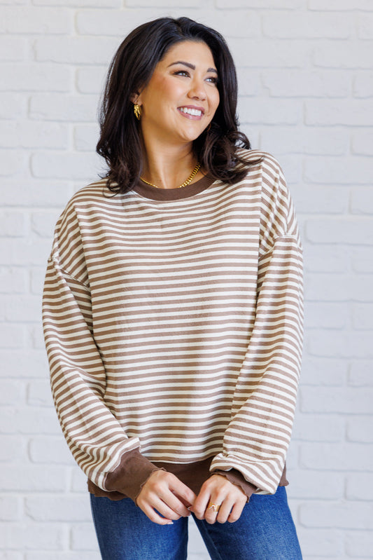 Women's brown striped drop shoulder top with long sleeves, banded ribbed neckline, cuffs, and hemline, made of midweight knit fabric.