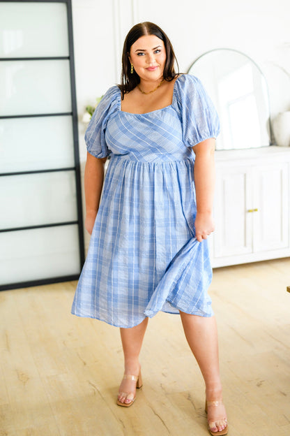 Plus size front view of Payson Puff Sleeve Midi Dress with smocked bodice, square neckline, and dramatic puff sleeves.