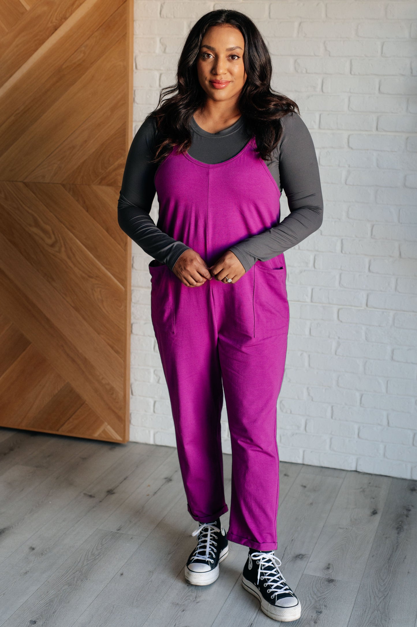 Light Plum spaghetti strap jumpsuit with a scooped neckline, patch pockets, and tacked cuffs at the hem.