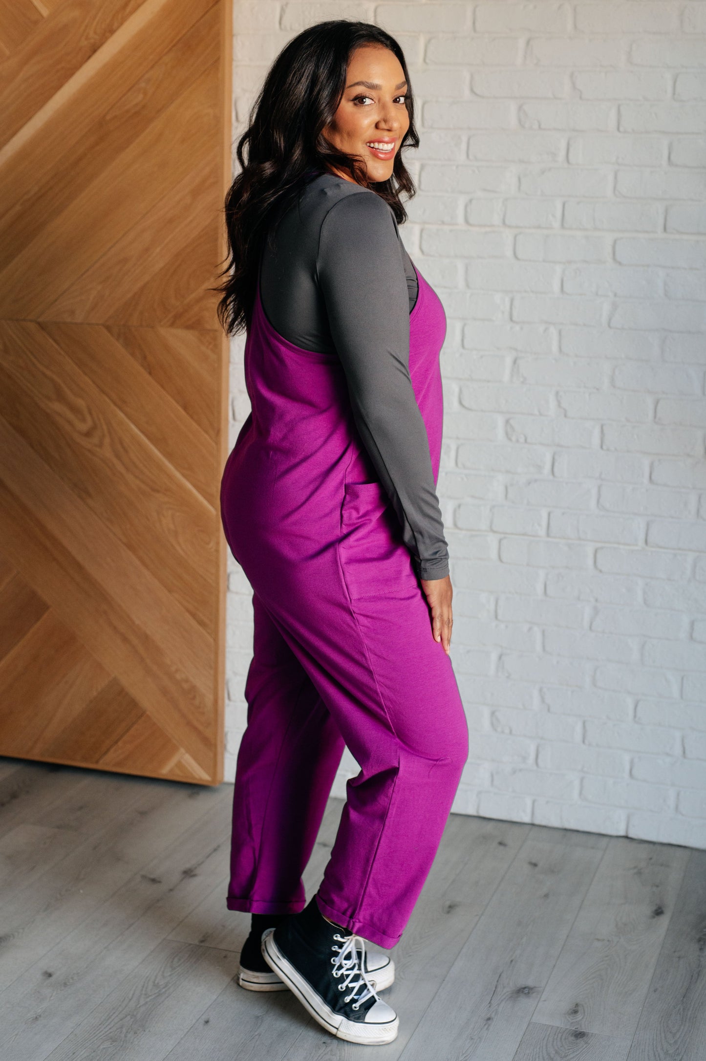 Light Plum spaghetti strap jumpsuit with a scooped neckline, patch pockets, and tacked cuffs at the hem.