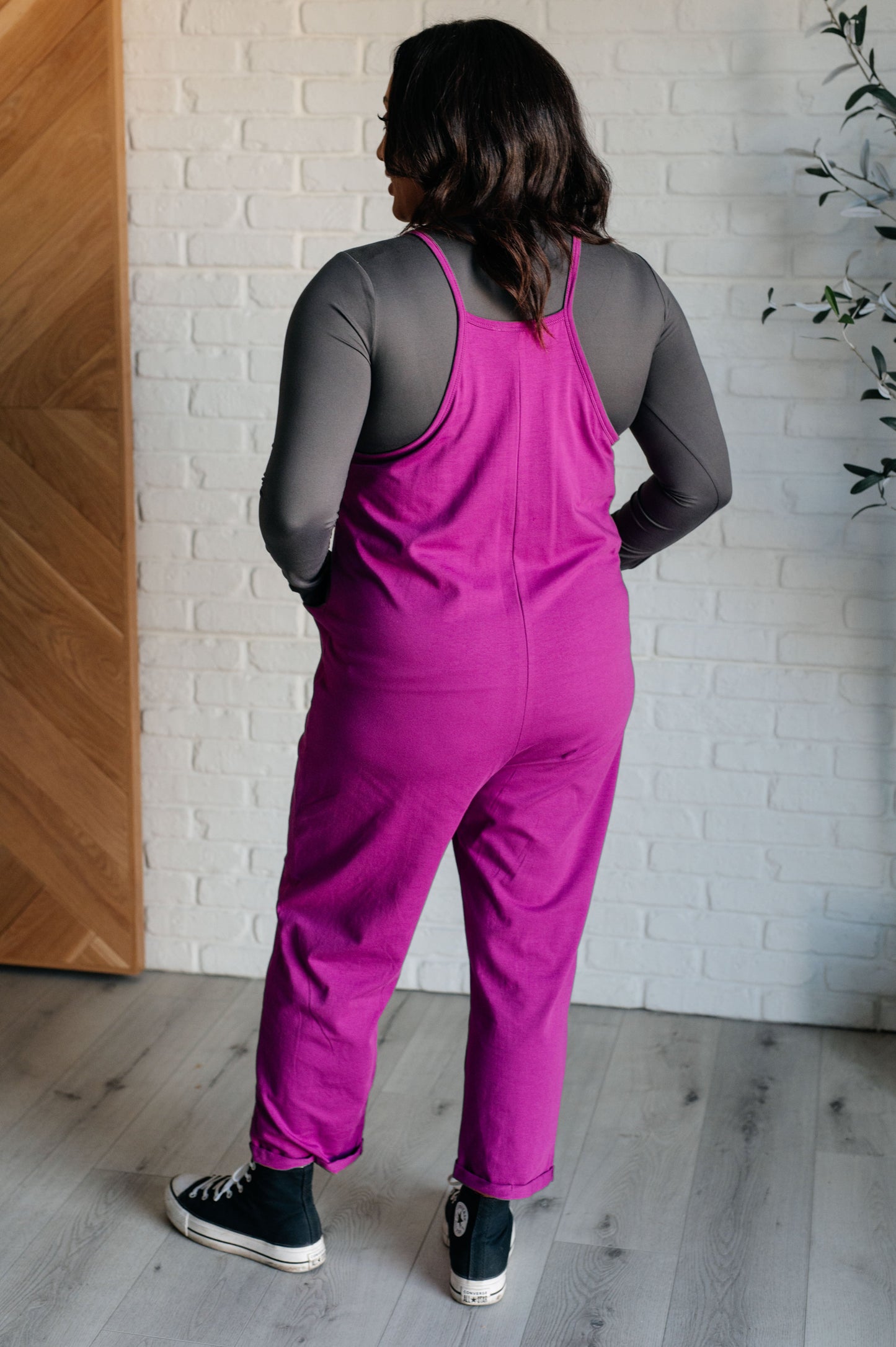 Light Plum spaghetti strap jumpsuit with a scooped neckline, patch pockets, and tacked cuffs at the hem.