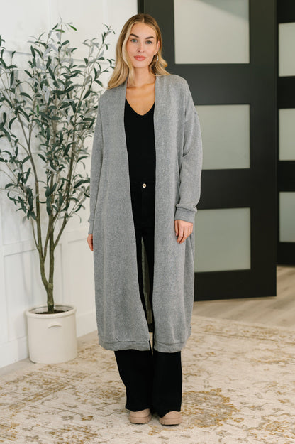 Model wearing Teagan Open Front Cardigan in gray with drop shoulders and banded cuffs.