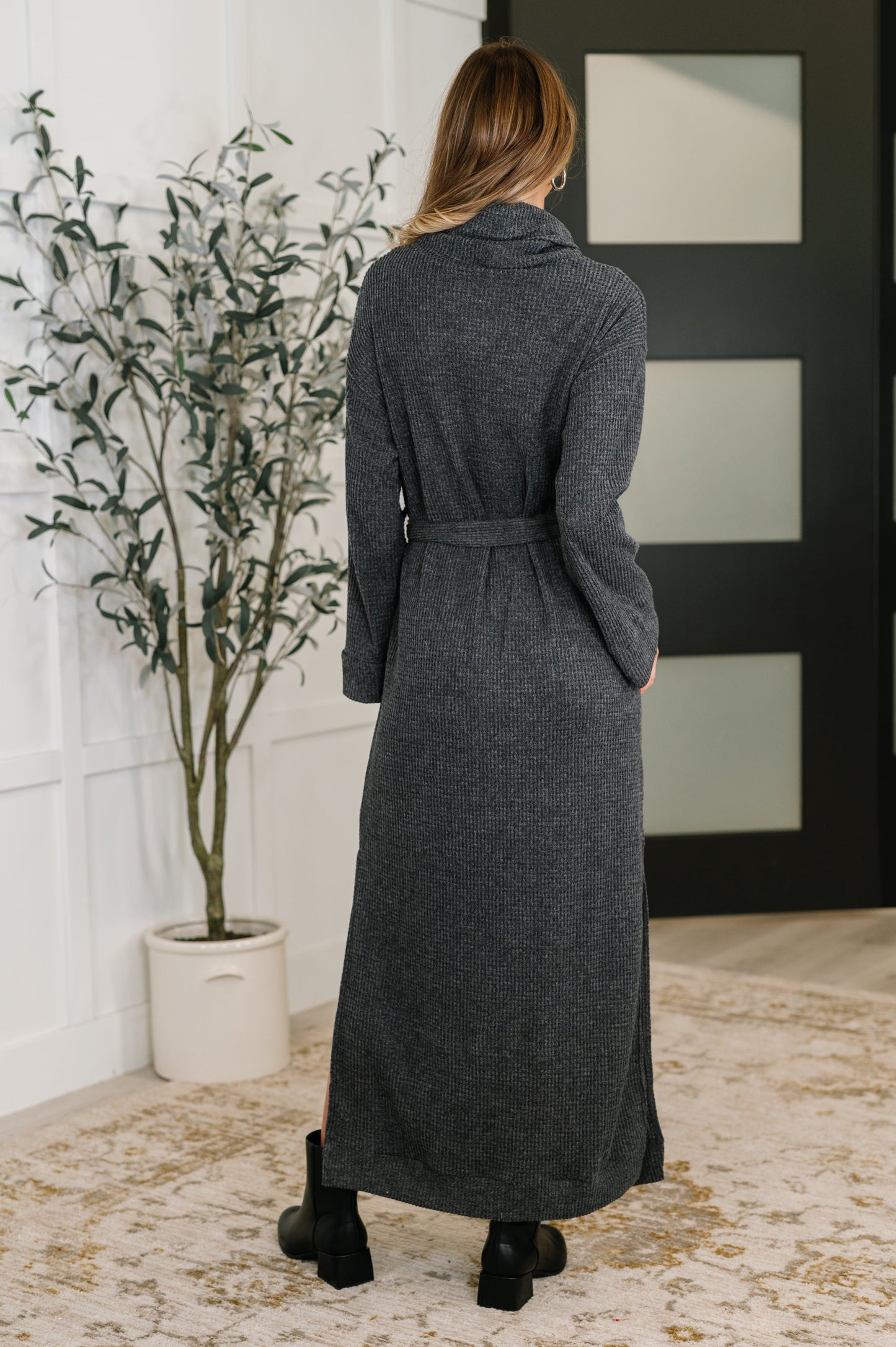 Back view of Travita Plush Knit Dress in Charcoal with banded cuffs and cozy fit.
